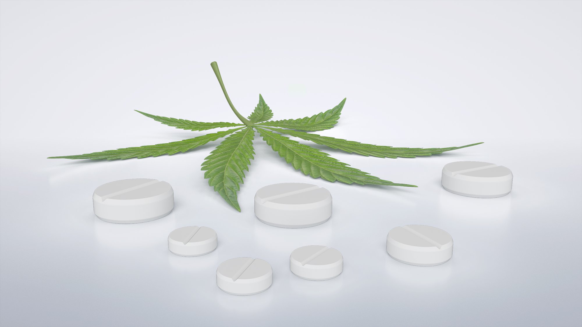 Weiße Nutraceutical-Tabletten, angeordnet um ein Cannabisblatt.