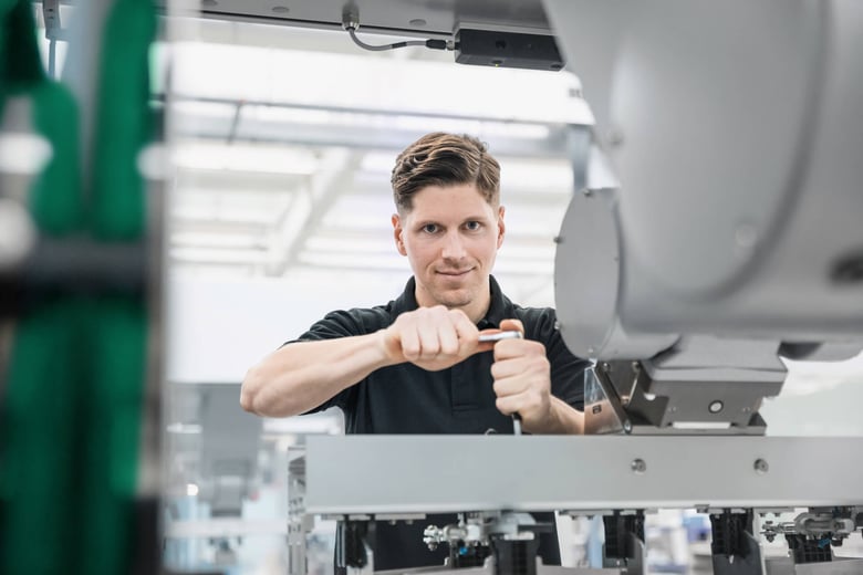 Technician assembling industrial machinery.