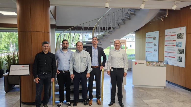 Project team posing in a corporate lobby