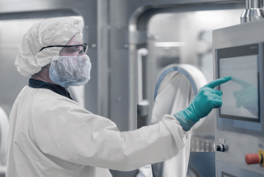 Operator using integrated isolator technology for aseptic RTU filling in a sterile pharmaceutical production environment