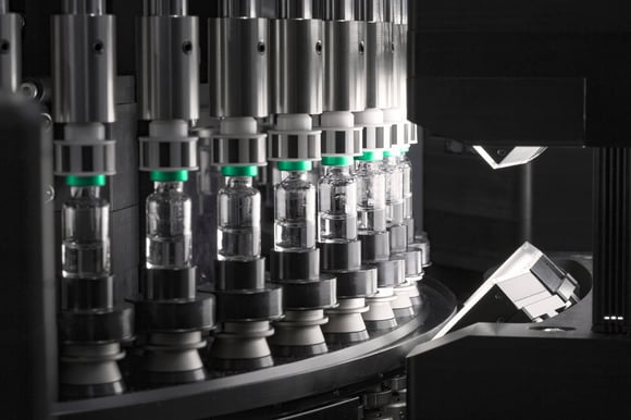 Automated camera inspection system checking glass vials on a production line