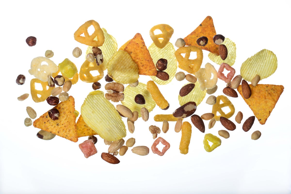 Variety of salty snacks and mixed nuts used in snack packaging solutions.