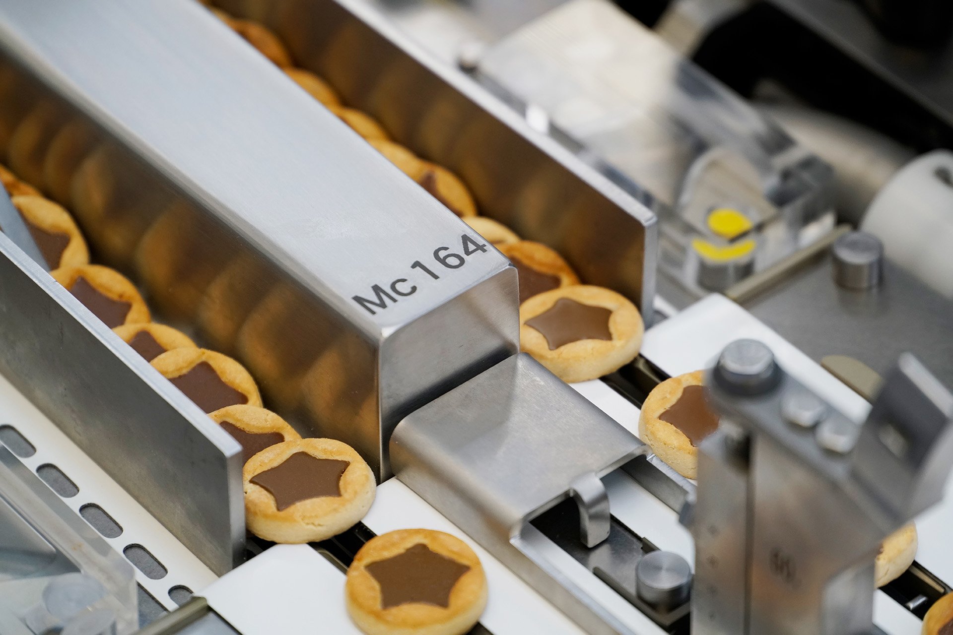Cookies moving through an automated food production line.