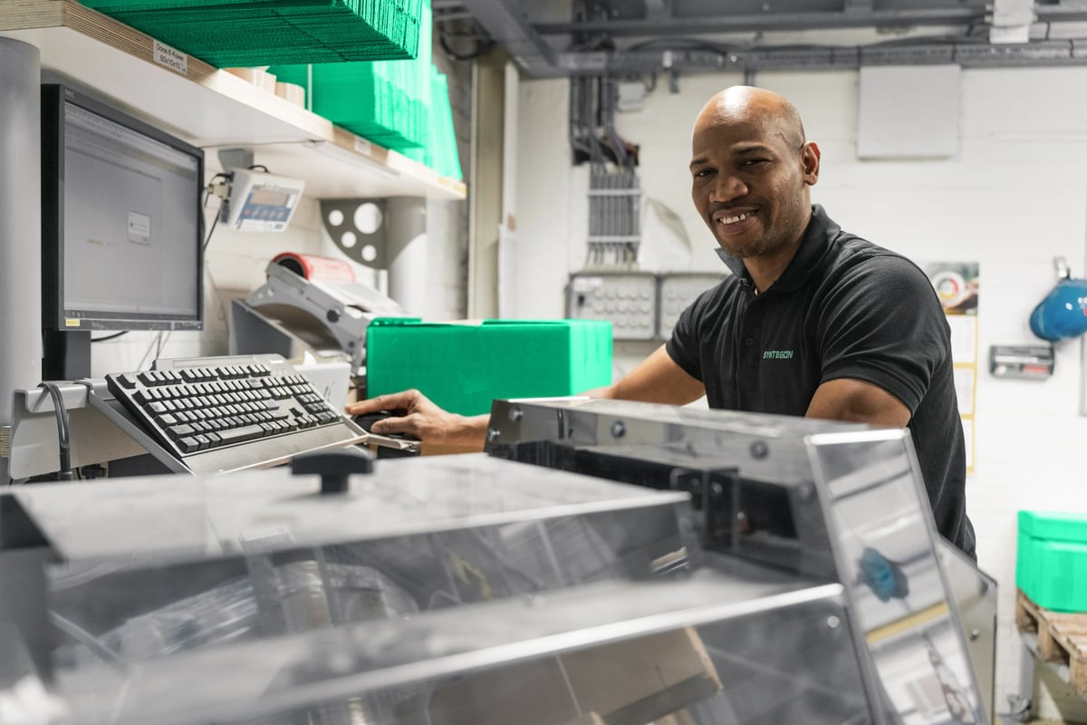 Technician working with industrial equipment, providing a testimonial for service agreements.