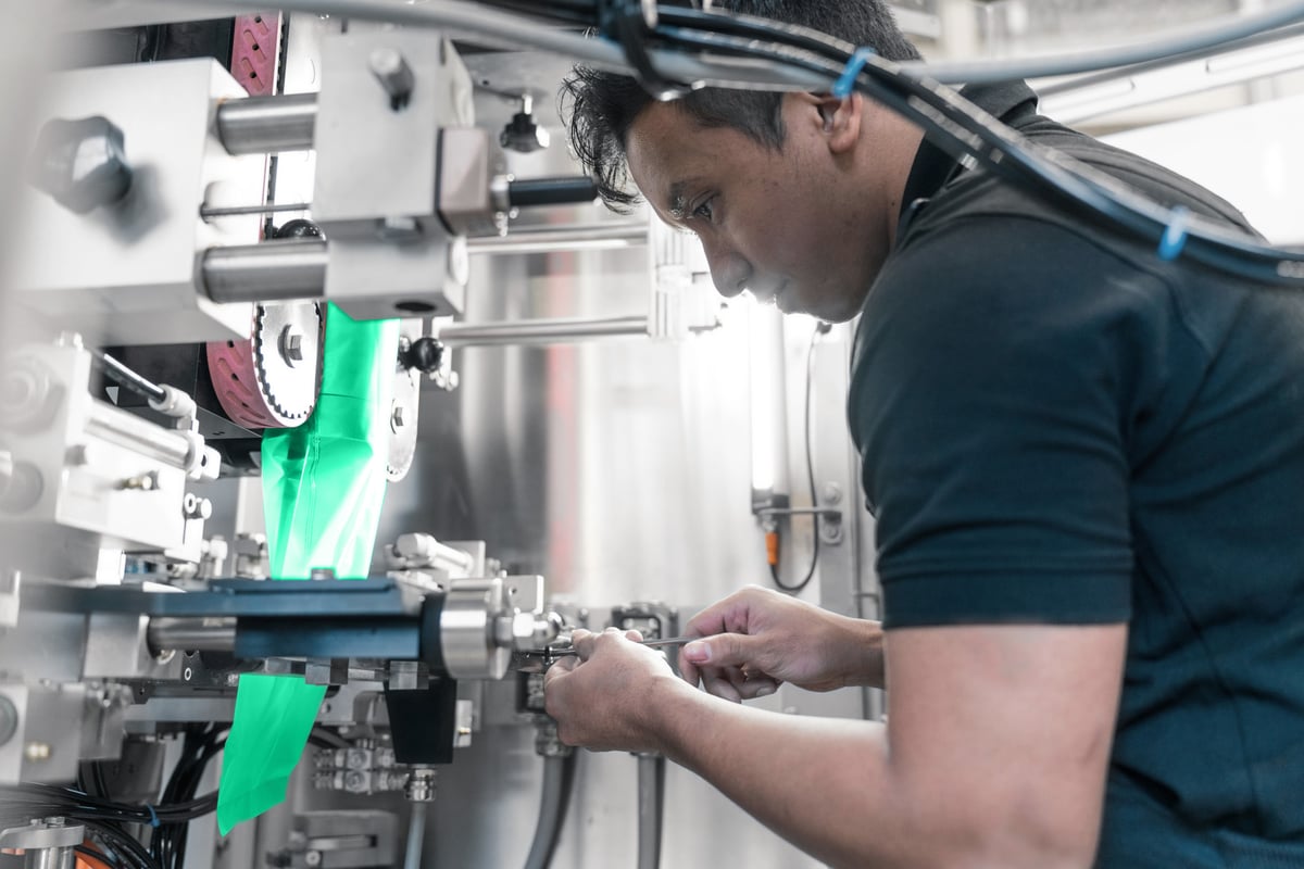 Technician performing maintenance on industrial machinery