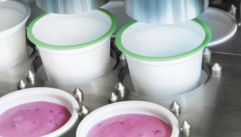 What does an Osgood Filling Machine put into cups?